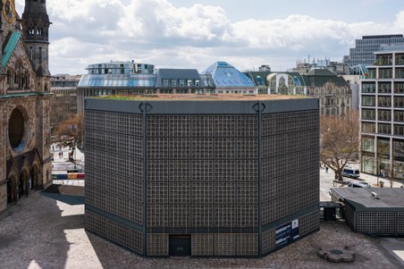 Das Foto zeigt die achteckige Kirche mit ihrer Betonwabenfassade.